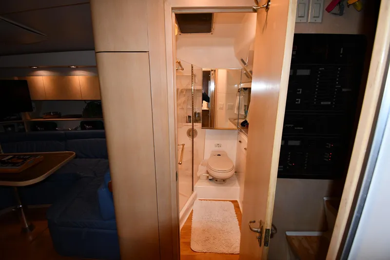 Slide: The Image of Interior of 1994 Tiara Yachts 4300 Open, featuring a compact bathroom and cozy living area. - 37