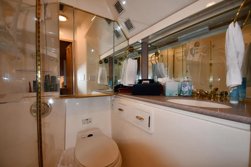 Slide: The Image of Luxurious bathroom in 1994 Tiara Yachts 4300 Open, featuring elegant fixtures and ample storage. - 38