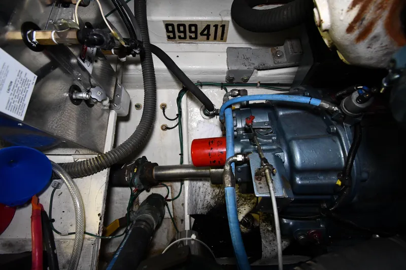 Slide: The Image of Engine compartment of a 1994 Tiara Yachts 4300 Open, showcasing mechanical components and wiring. - 48