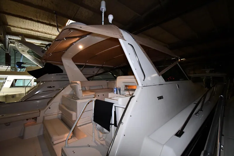 Slide: The Image of 1994 Tiara Yachts 4300 Open in a dimly lit indoor storage area. - 5