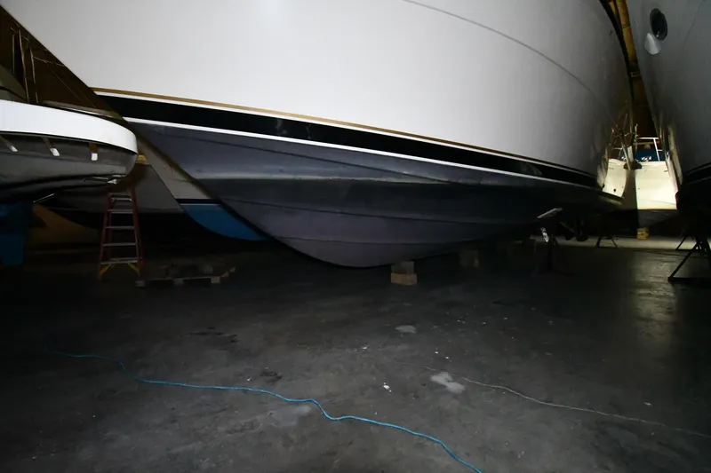 Slide: The Image of 1994 Tiara Yachts 4300 Open in storage, showcasing hull and sleek design. - 51