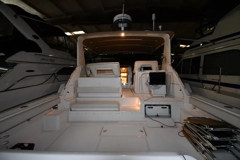 Slide: The Image of 1994 Tiara Yachts 4300 Open interior view, showcasing spacious deck and seating area. - 6