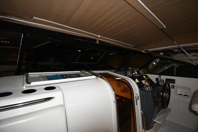 Slide: The Image of 1994 Tiara Yachts 4300 Open cockpit with helm, steering wheel, and navigation instruments. - 7