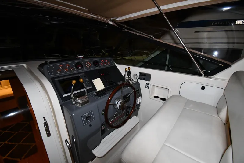 Slide: The Image of 1994 Tiara Yachts 4300 Open helm with steering wheel and control panel. - 8
