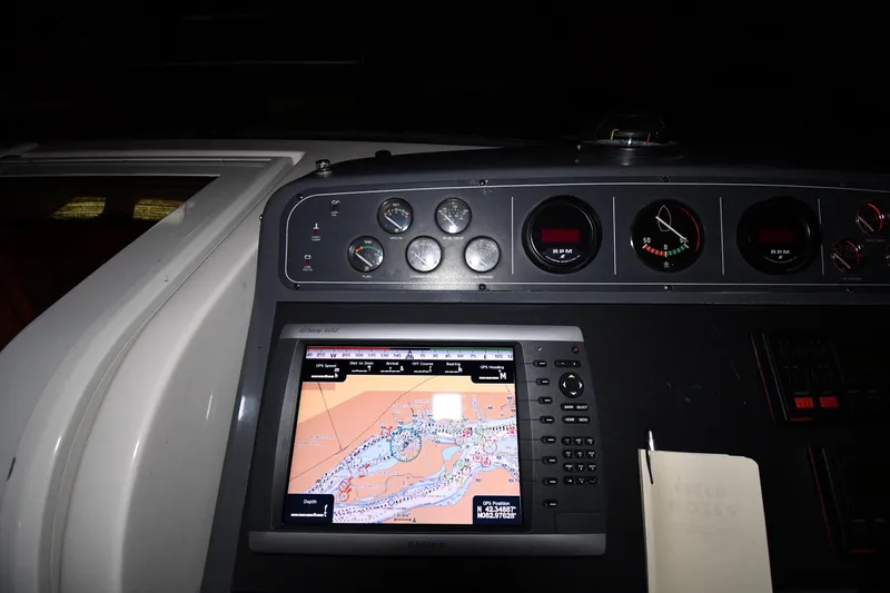 Slide: The Image of Dashboard of a 1994 Tiara Yachts 4300 Open with navigation system and gauges. - 9