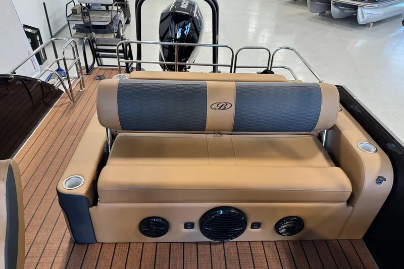 Slide: The Image of 2026 Bentley Pontoons Elite 223 Swingback with tan and gray seating, cup holders, and speakers. - 7