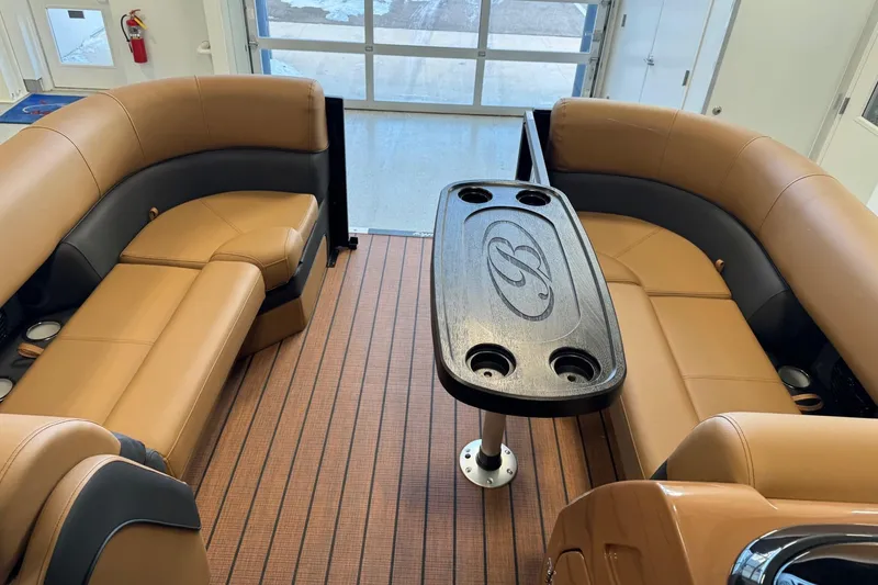 Slide: The Image of Luxurious interior of 2026 Bentley Pontoons Elite 223 Swingback with tan seating and central table. - 8