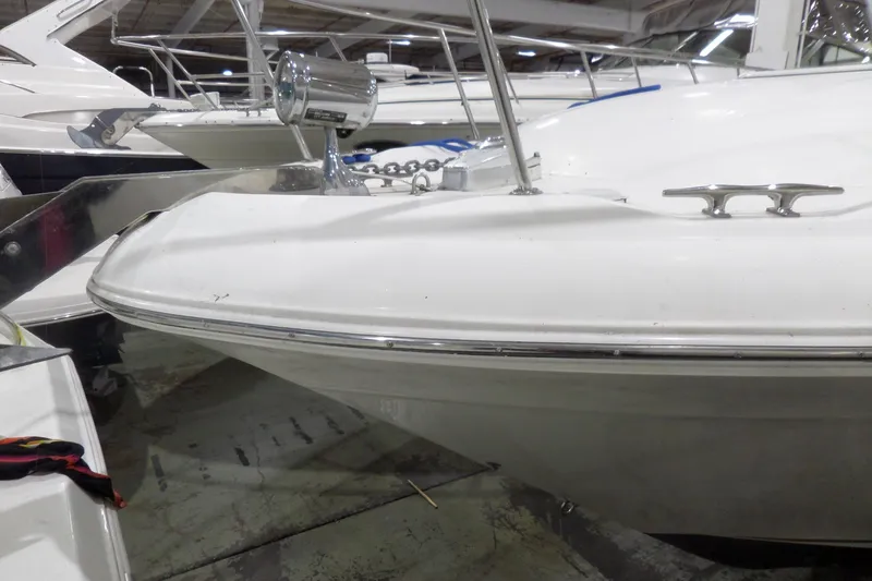 Slide: The Image of 2000 Sea Ray 340 Sundancer boat in storage, showcasing bow and deck details. - 1