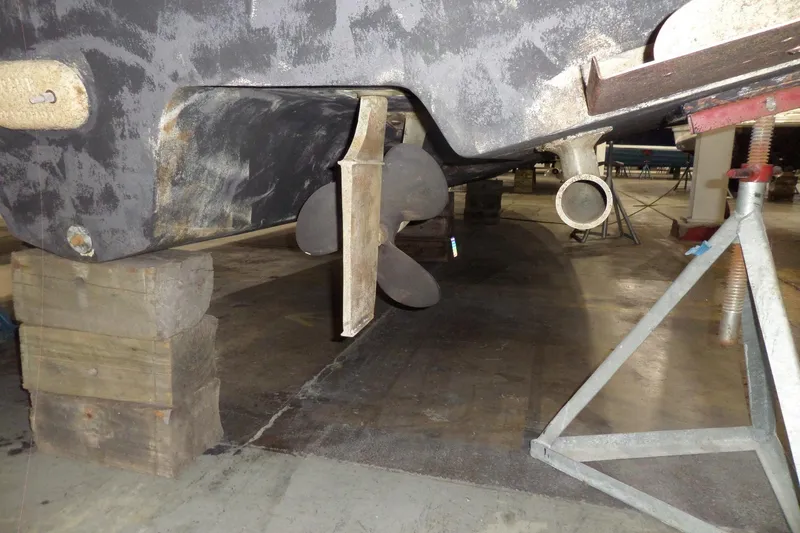 Slide: The Image of 2000 Sea Ray 340 Sundancer boat propeller and rudder on dry dock. - 10