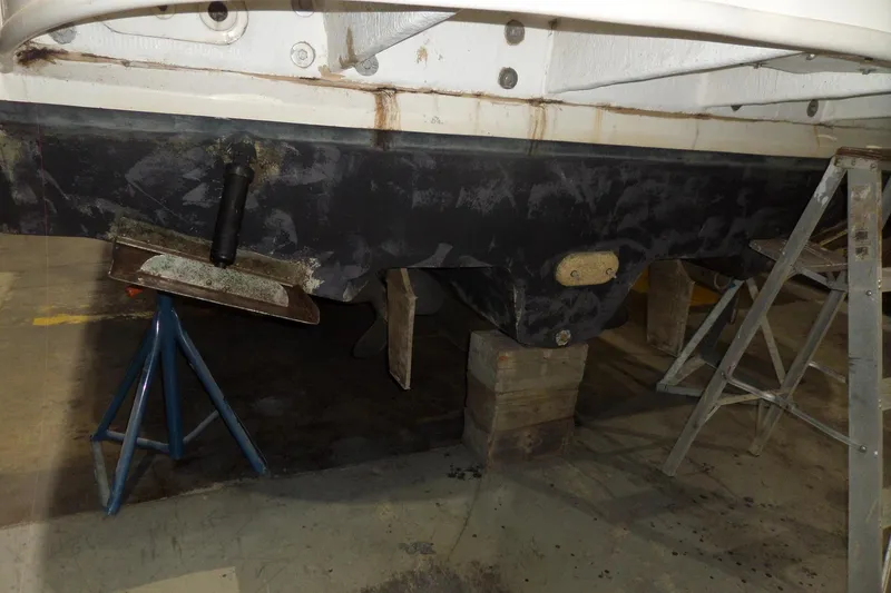 Slide: The Image of 2000 Sea Ray 340 Sundancer hull on stands in a workshop. - 11