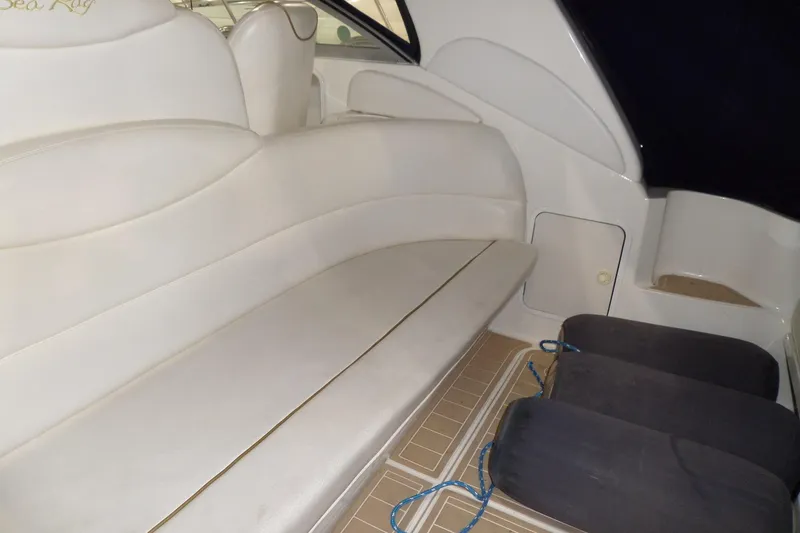Slide: The Image of Interior seating of 2000 Sea Ray 340 Sundancer boat with white upholstery. - 14