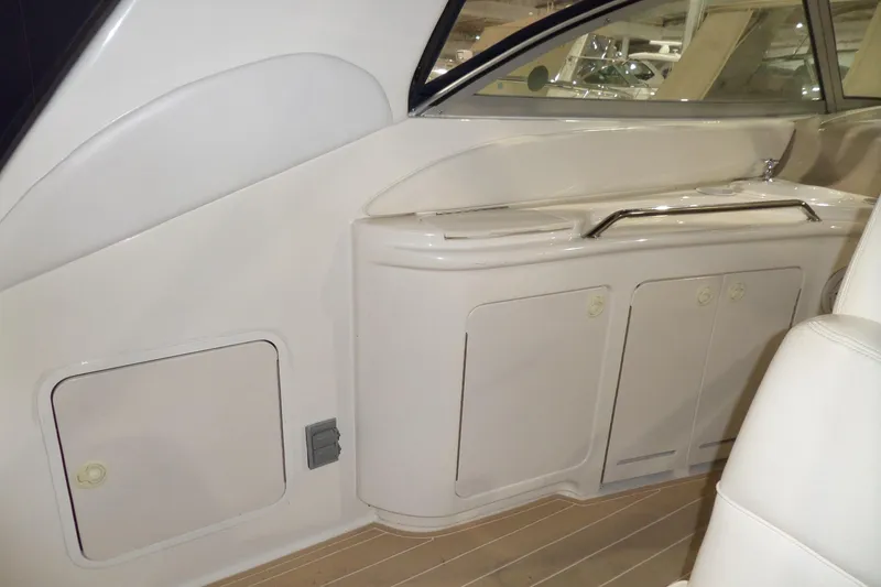Slide: The Image of Interior view of a 2000 Sea Ray 340 Sundancer boat, featuring sleek cabinetry and seating. - 17