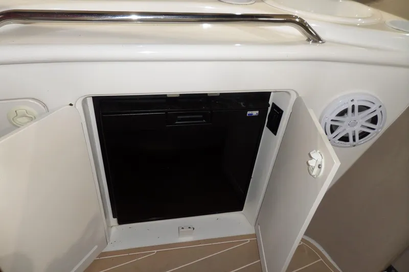 Slide: The Image of 2000 Sea Ray 340 Sundancer interior with open cabinet and speaker. - 18