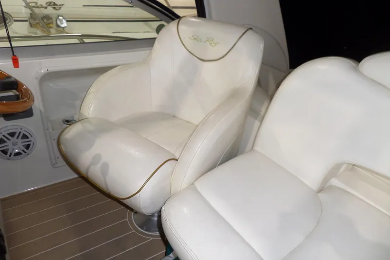 Slide: The Image of White leather seats on a 2000 Sea Ray 340 Sundancer boat interior. - 21
