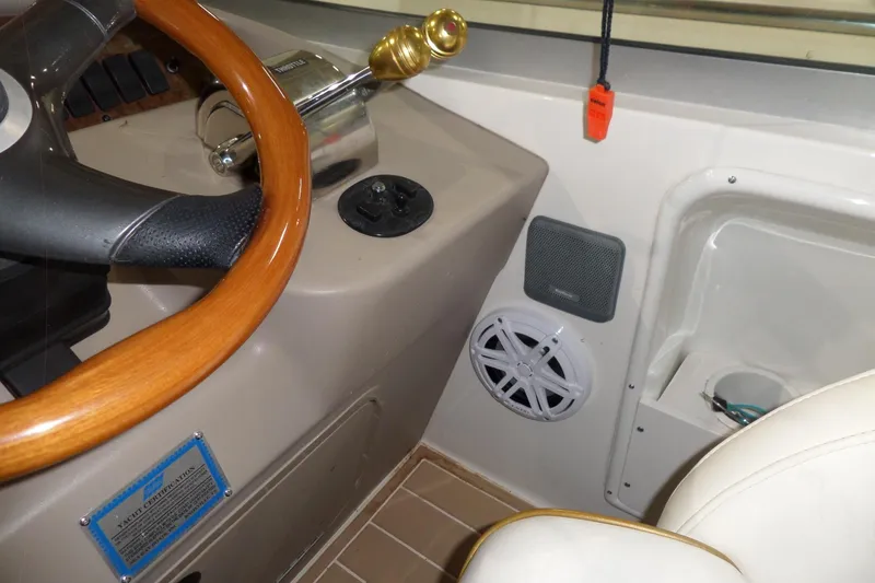 Slide: The Image of Helm of 2000 Sea Ray 340 Sundancer with wooden steering wheel and control panel. - 34