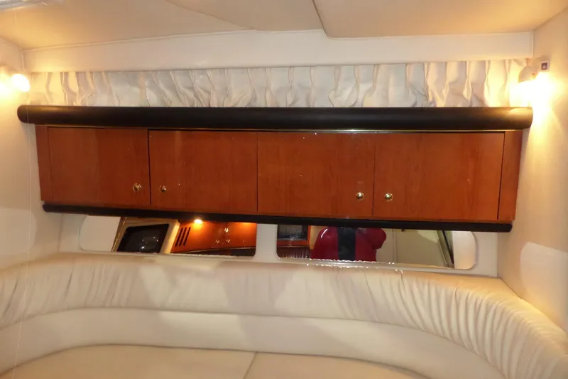 Slide: The Image of Interior cabin of 2000 Sea Ray 340 Sundancer with wooden cabinets and cushioned seating. - 39