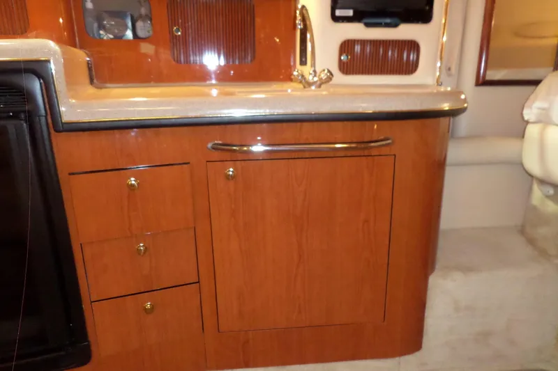 Slide: The Image of Interior of a 2000 Sea Ray 340 Sundancer yacht with wooden cabinetry and countertop. - 49