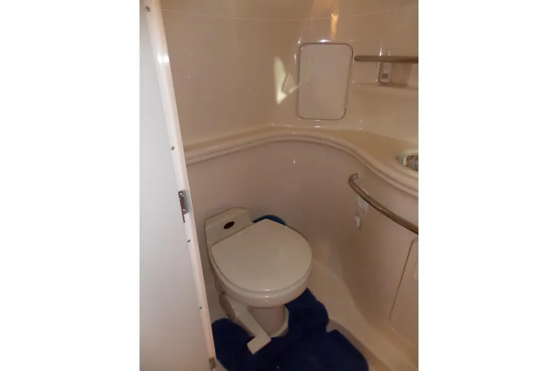 Slide: The Image of Bathroom interior of 2000 Sea Ray 340 Sundancer yacht, featuring a compact toilet. - 52