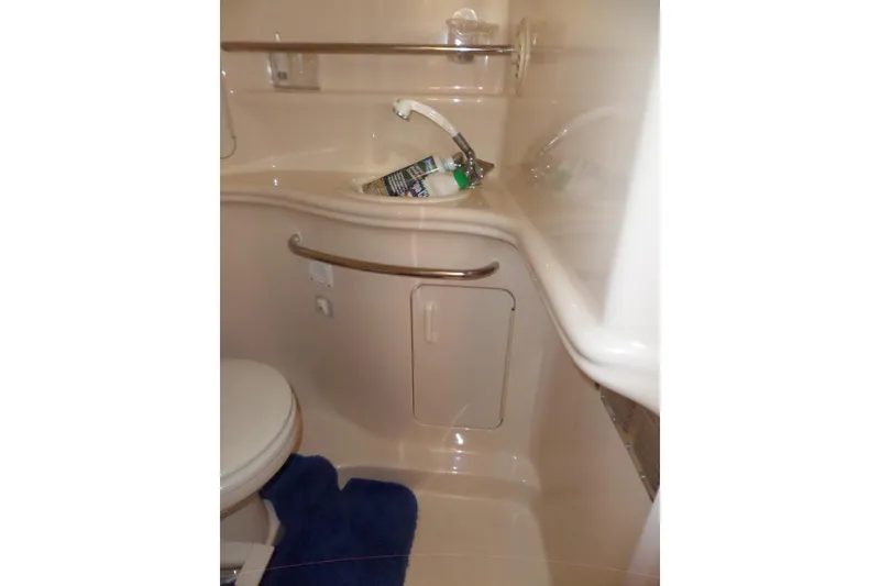 Slide: The Image of Bathroom interior of 2000 Sea Ray 340 Sundancer yacht, featuring sink and toilet. - 54