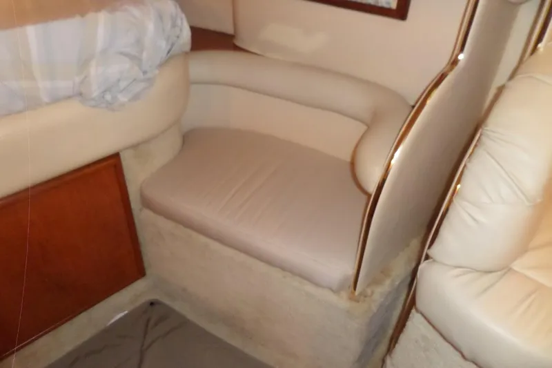 Slide: The Image of Interior seating area of 2000 Sea Ray 340 Sundancer yacht, featuring beige upholstery. - 55