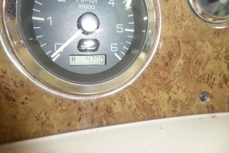 Slide: The Image of Tachometer of 2000 Sea Ray 340 Sundancer showing 4300 RPM on wood grain dashboard. - 56