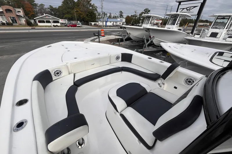 Slide: The Image of 2023 Tidewater 2700 Carolina Bay boat interior with cushioned seating and speakers. - 12
