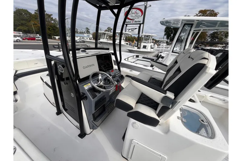 Slide: The Image of 2023 Tidewater 2700 Carolina Bay boat interior with Garmin navigation system and comfortable seating. - 13