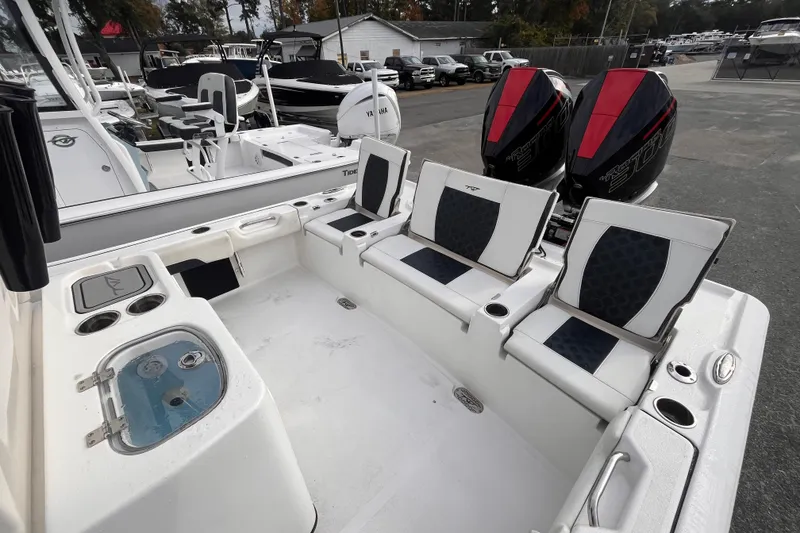 Slide: The Image of 2023 Tidewater 2700 Carolina Bay boat interior with seating and dual engines. - 14
