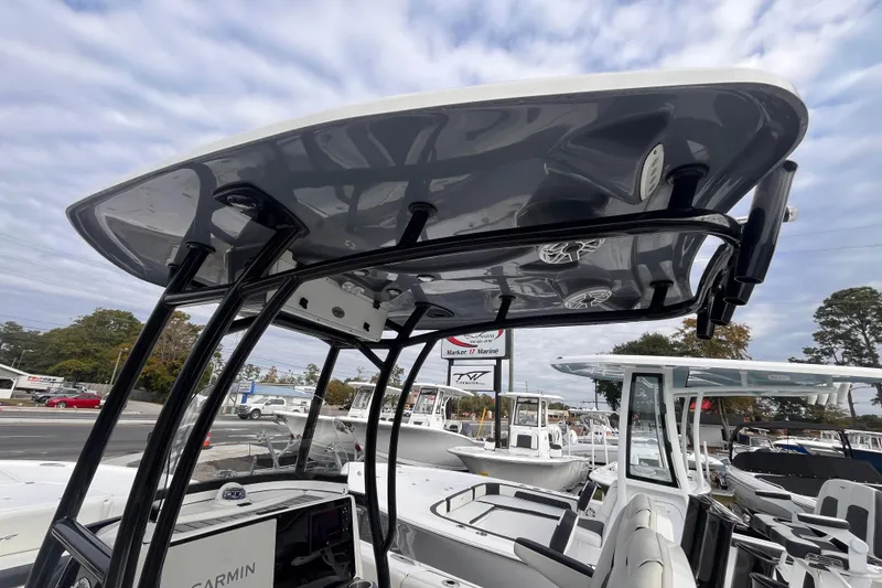 Slide: The Image of 2023 Tidewater 2700 Carolina Bay boat with T-top and Garmin electronics, displayed outdoors. - 15