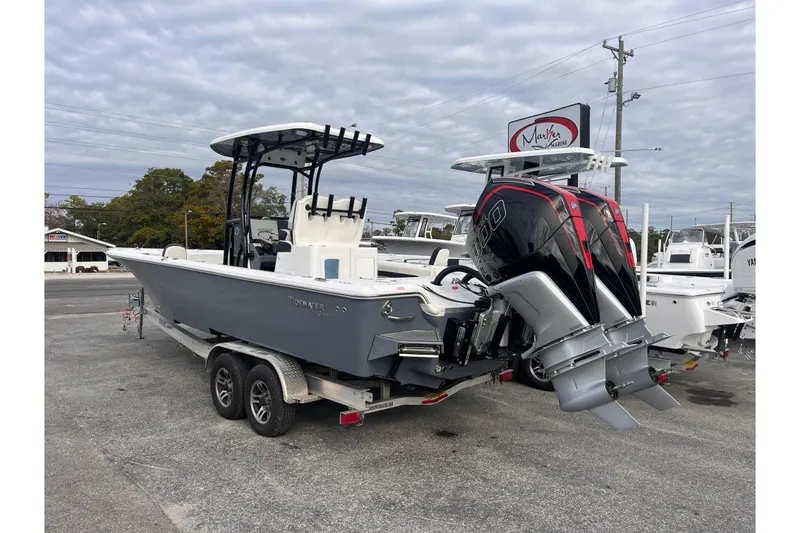 Slide: The Image of 2023 Tidewater 2700 Carolina Bay boat with dual engines on a trailer. - 2
