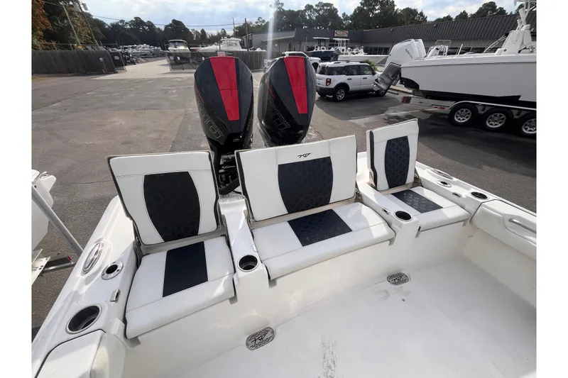 Slide: The Image of 2023 Tidewater 2700 Carolina Bay boat with dual engines and cushioned seating. - 5