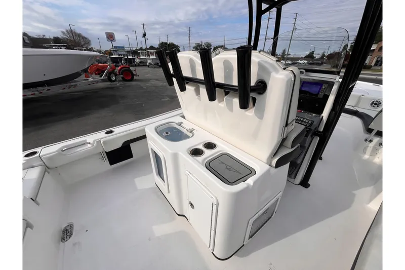 Slide: The Image of 2023 Tidewater 2700 Carolina Bay boat interior with console and rod holders. - 6