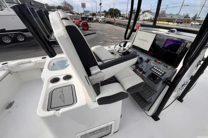 Slide: The Image of 2023 Tidewater 2700 Carolina Bay boat interior with Garmin navigation system and seating. - 7