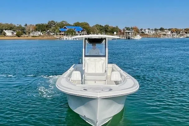 Slide: The Image of 2026 Pair Customs 24 Center Console DV boat cruising on clear blue water. - 4
