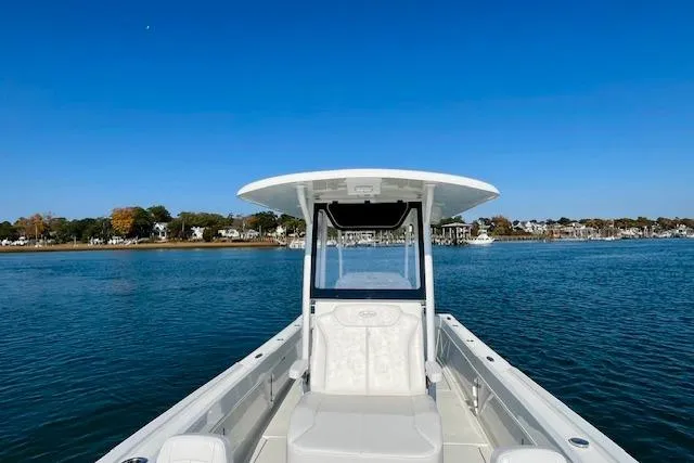 Slide: The Image of 2026 Pair Customs 24 Center Console DV boat on calm water, clear blue sky. - 5