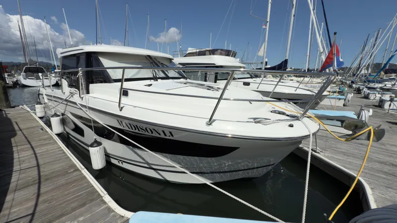 Slide: The Image of 2019 Jeanneau NC Weekender 1095 docked at a marina, showcasing sleek design and modern features. - 1