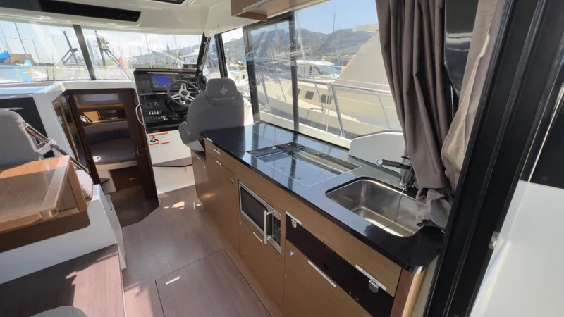 Slide: The Image of Interior of 2019 Jeanneau NC Weekender 1095 with modern kitchen and helm station. - 14