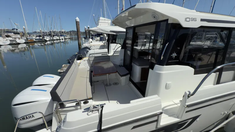 Slide: The Image of 2019 Jeanneau NC Weekender 1095 docked, featuring spacious deck and Yamaha engines. - 23