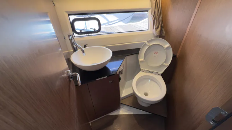 Slide: The Image of 2019 Jeanneau NC Weekender 1095 bathroom with sink and toilet. - 26
