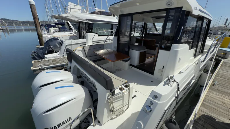 Slide: The Image of 2019 Jeanneau NC Weekender 1095 docked, featuring twin Yamaha outboard engines. - 4