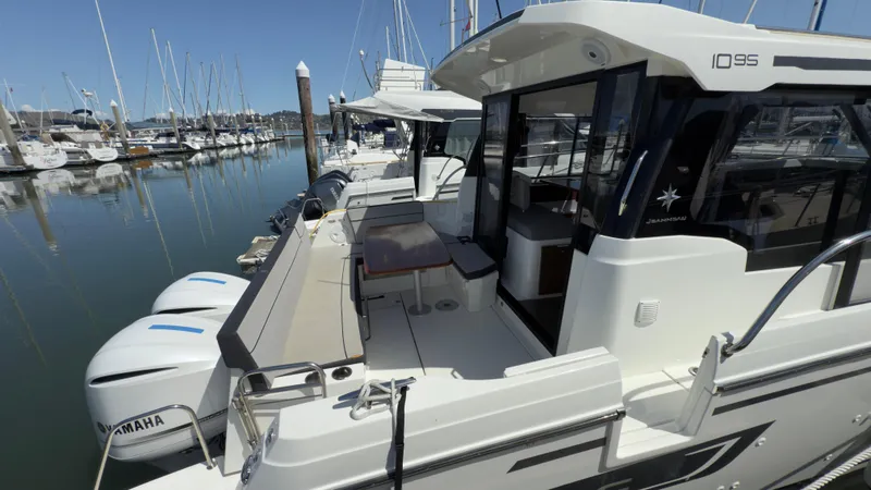 Slide: The Image of 2019 Jeanneau NC Weekender 1095 docked, featuring spacious deck and Yamaha engines. - 5