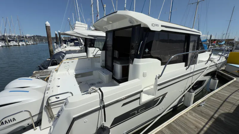 Slide: The Image of 2019 Jeanneau NC Weekender 1095 docked at marina with Yamaha engines. - 8