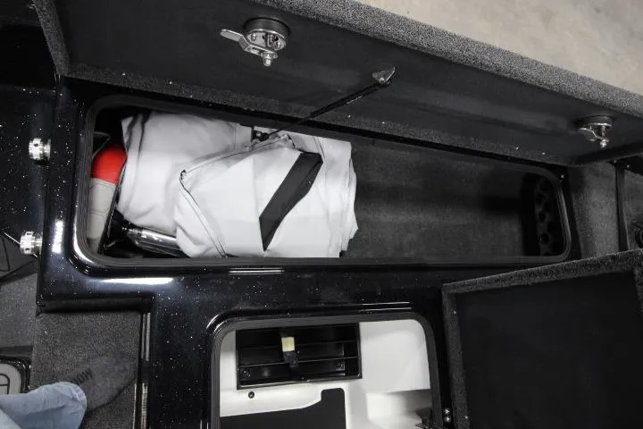 Slide: The Image of 2026 BassCat CougarFTDSP storage compartment with gear and equipment inside. - 10