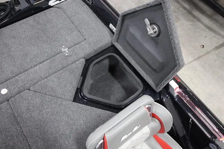 Slide: The Image of 2026 BassCat CougarFTDSP boat storage compartment with open lid and cushioned seat. - 15