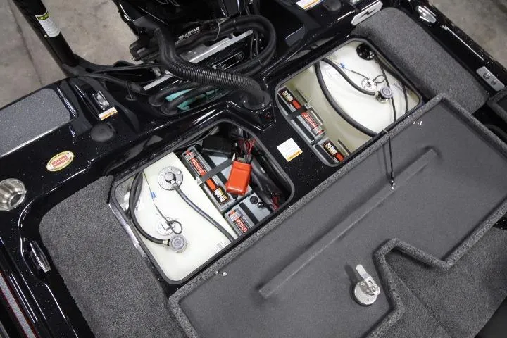 Slide: The Image of 2026 BassCat Cougar FTD SP boat battery compartment with dual batteries and wiring. - 17