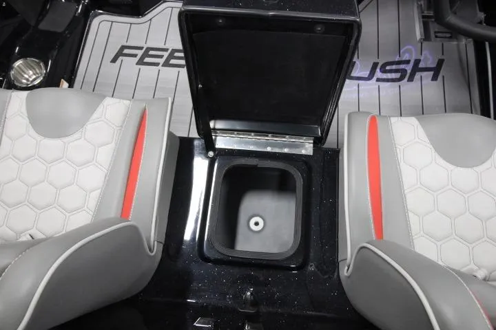 Slide: The Image of 2026 BassCat Cougar FTD SP interior with open storage compartment between seats. - 19