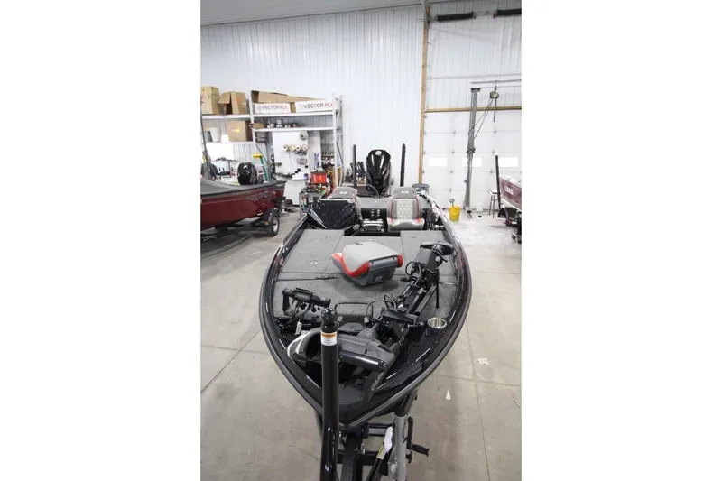 Slide: The Image of 2026 BassCat Cougar FTDSP boat in a garage, showcasing interior and equipment. - 23