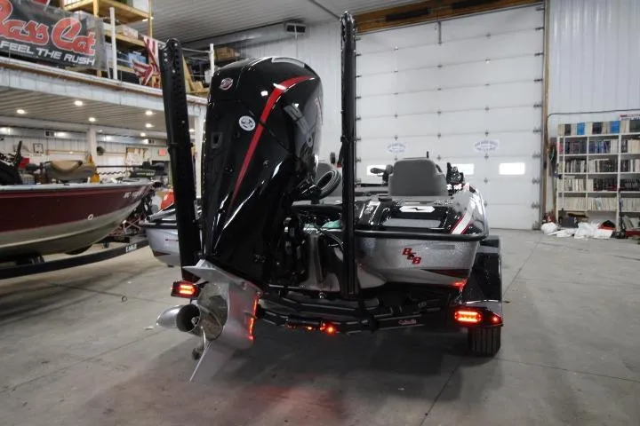 Slide: The Image of 2026 BassCat Cougar FTDSP boat in a garage, rear view with motor and trailer. - 4