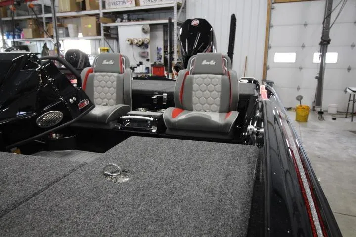 Slide: The Image of 2026 BassCat Cougar FTDSP boat interior with dual seats in a garage setting. - 5