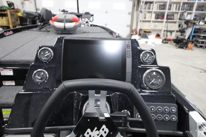 Slide: The Image of 2026 BassCat Cougar FTDSP boat dashboard with steering wheel and digital display. - 6